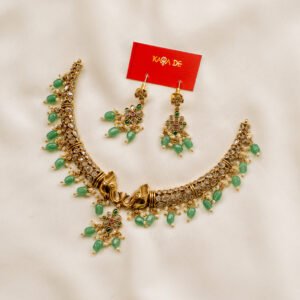 Antique gold neckpiece with elephant motifs, emerald drops, and Kundan-style stones – Karra De