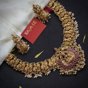 Antique Lakshmi gold necklace set with ruby stones and pearls on black fabric – Karra De.