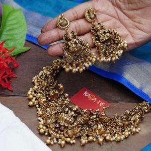 Antique Lakshmi gold necklace set with ruby stones and pearls on black fabric – Karra De.