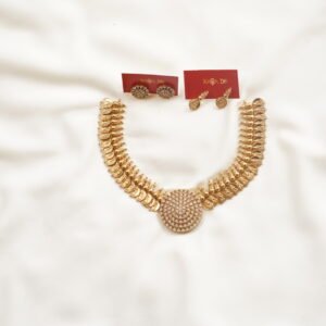 Gold coin necklace with circular pendant and two earring sets on cream fabric – Karra De.